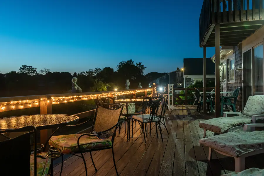 Deck lit with string lights at dusk
