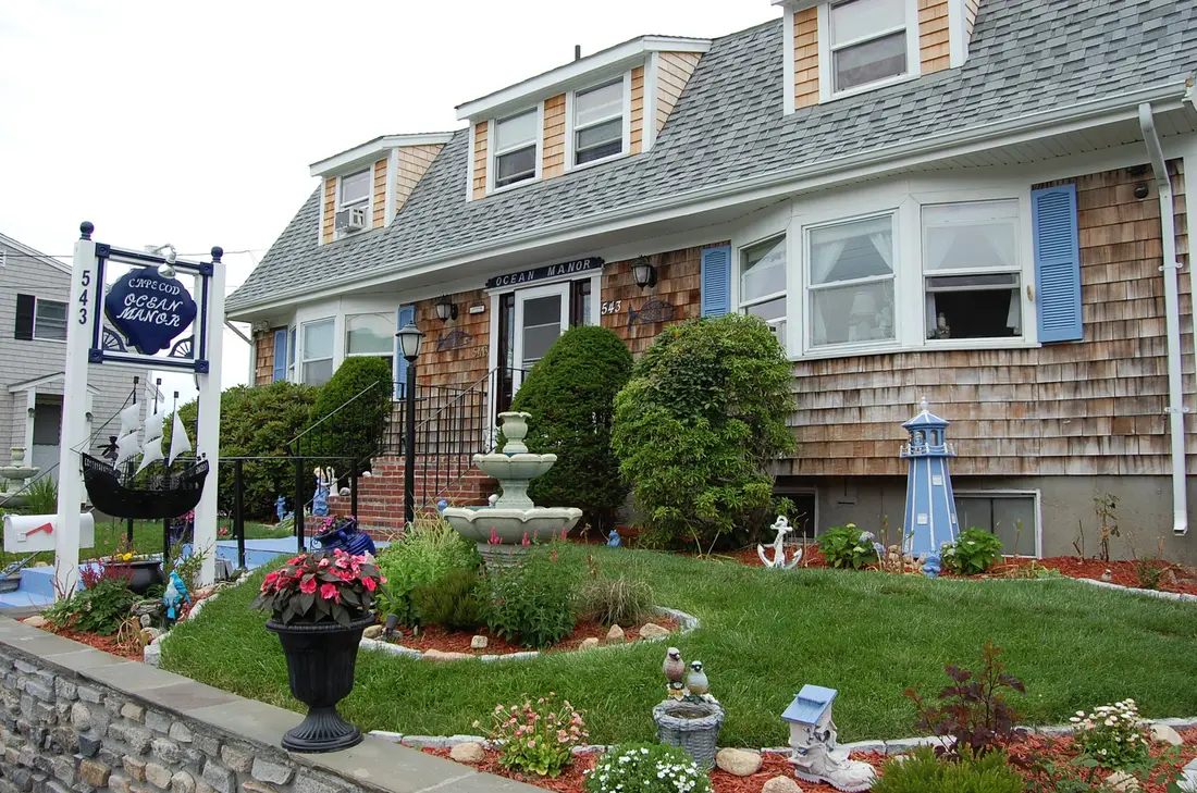 Front of Cape Cod Ocean Manor with garden and fountain