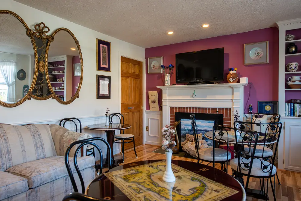 Guest lounge with fireplace and cafe tables