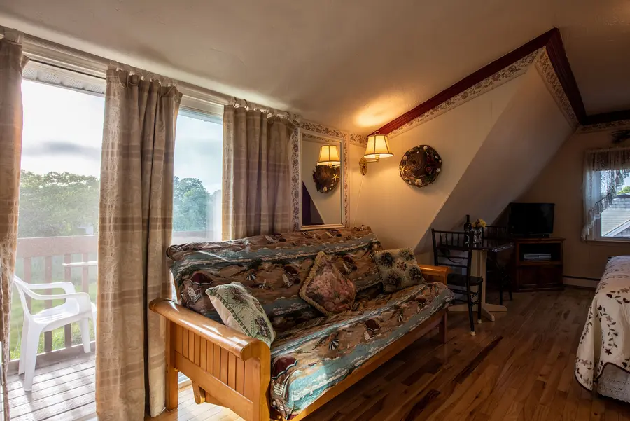 Guest room with futon seating and deck access