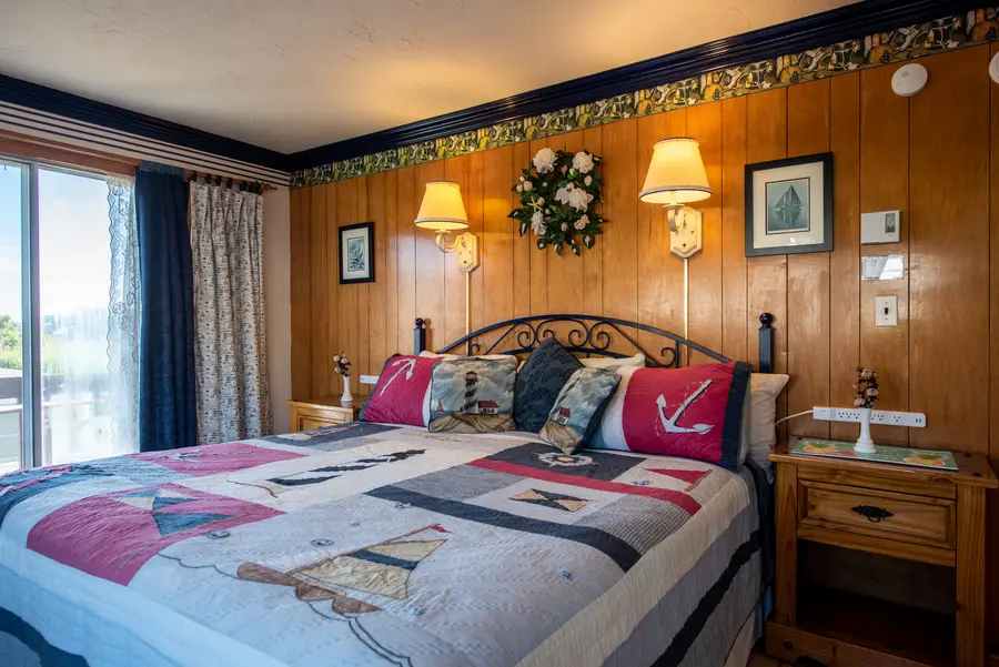 Wood-paneled room with nautical quilt